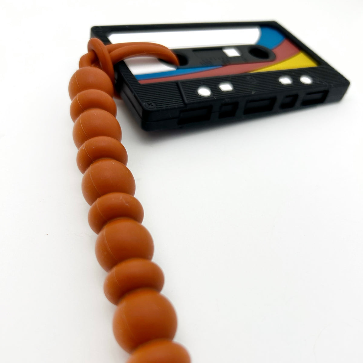 Cassette Mix Tape Teether with colorful design and silicone beads for teething relief inspired by 80s and 90s nostalgia.
