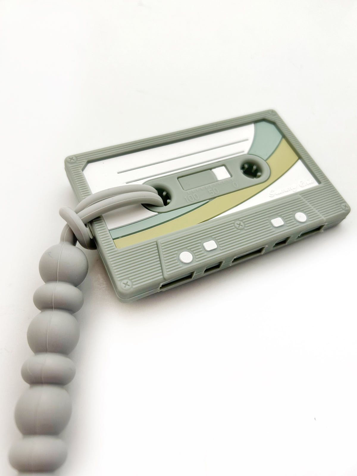 Cassette Mix Tape Teether in retro design with soft beads for teething relief, showcasing 80s and 90s nostalgia.