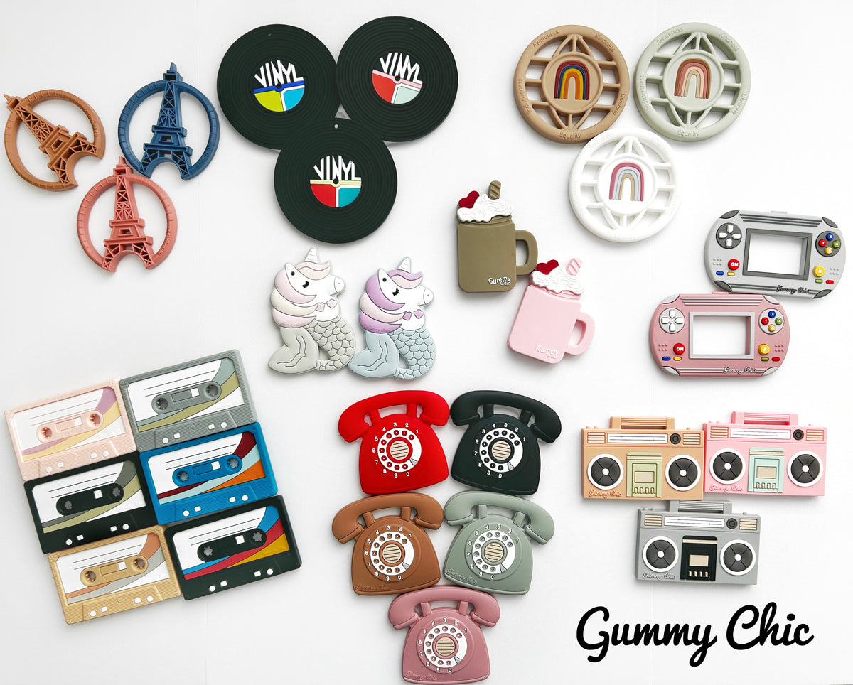 Colorful collection of teething toys including Cassette Mix Tape Teether representing retro 80s and 90s styles.