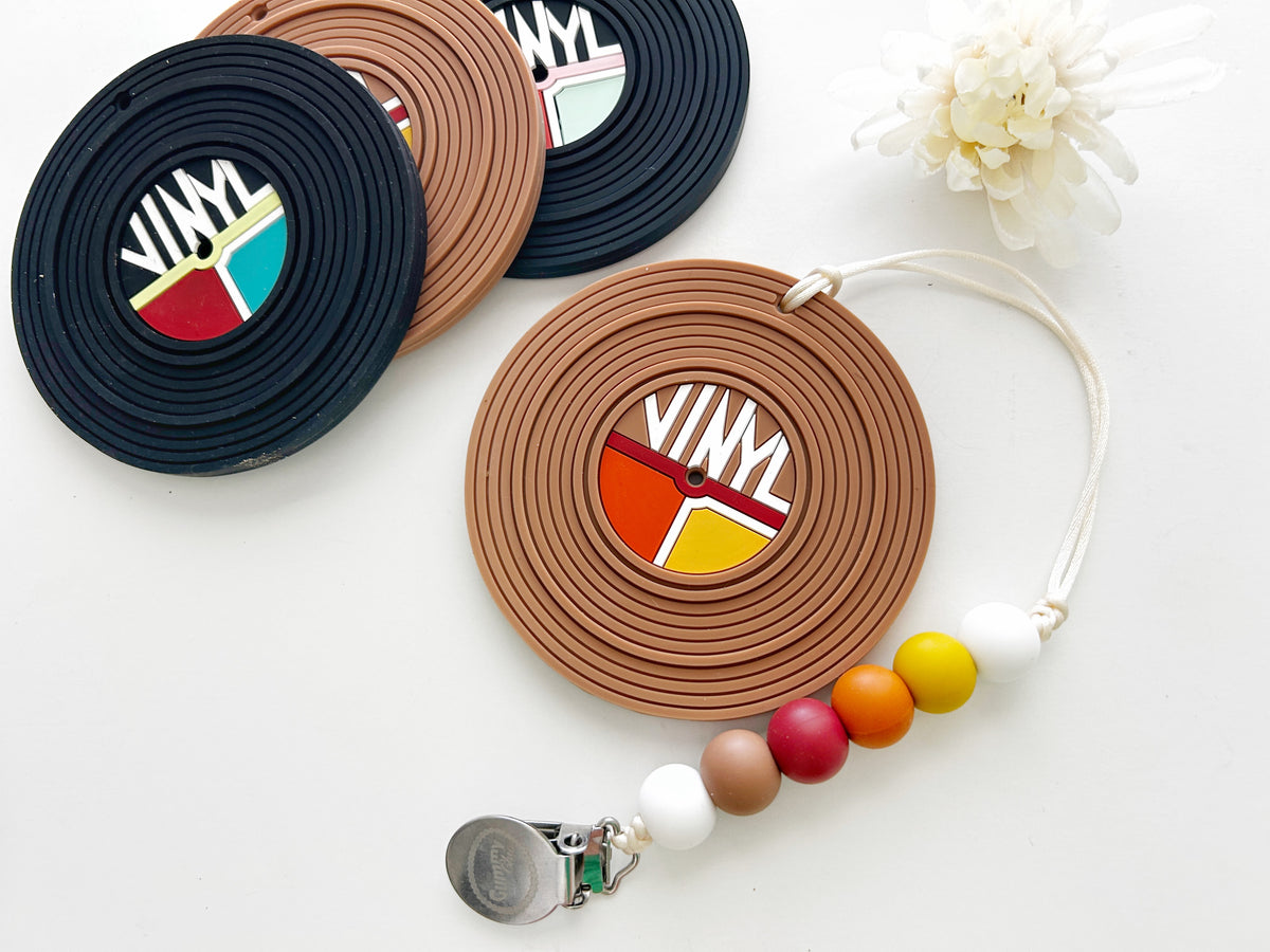 vinyl record silicone baby teether with clip and colorful beads, perfect for teething comfort and sensory needs.