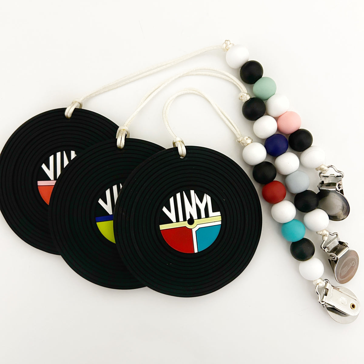 vinyl record silicone baby teether toy with clip in black and colorful designs featuring retro style