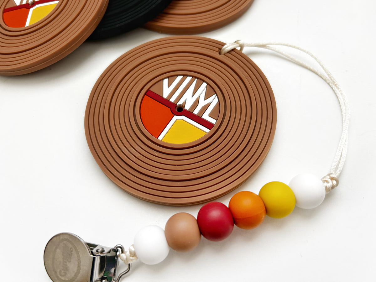 Vinyl record silicone baby teether with colorful beads and clip for easy attachment.