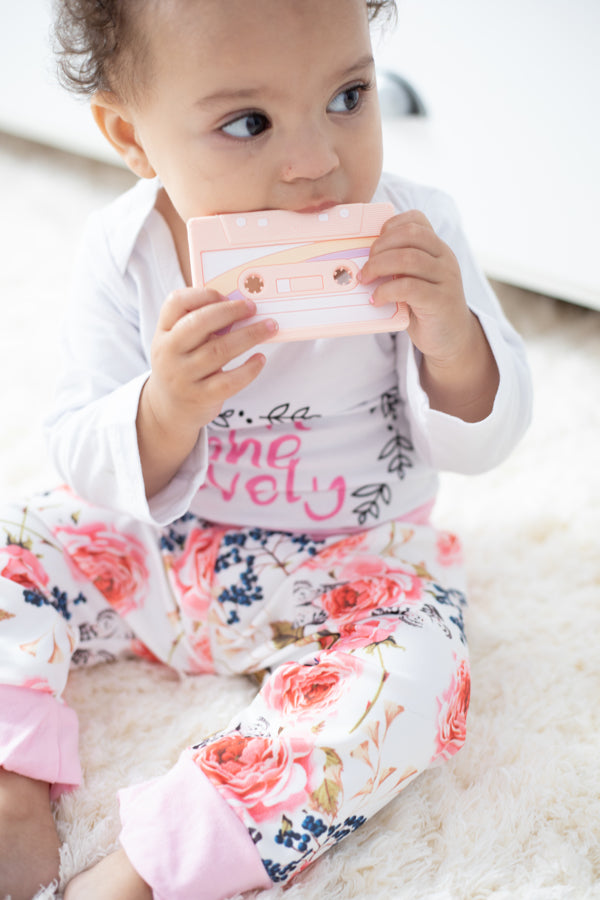 Baby chewing on a Cassette Mix Tape Teether, showcasing retro 80s and 90s design for teething relief.