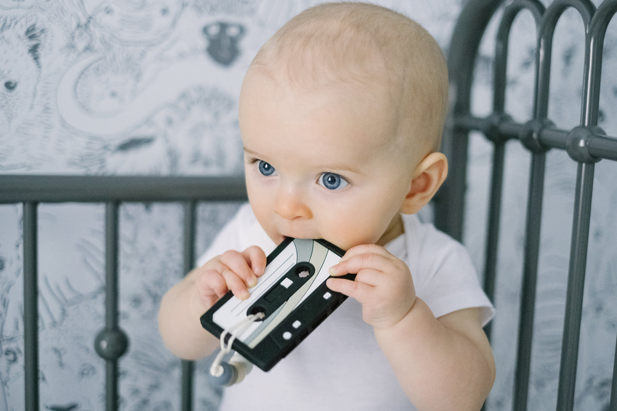 Baby chewing on a Cassette Mix Tape Teether, combining retro 80s & 90s vibes with teething relief.