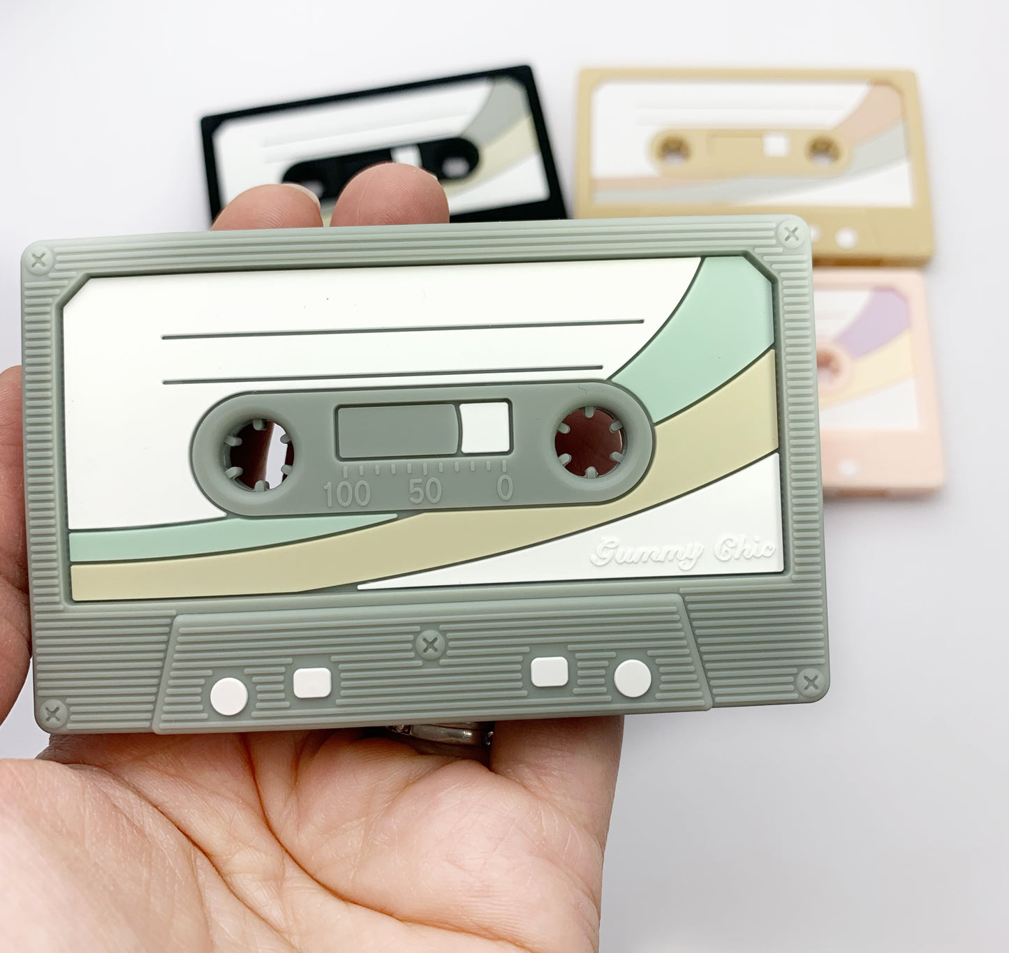 detail of a grey and green mix tape teether