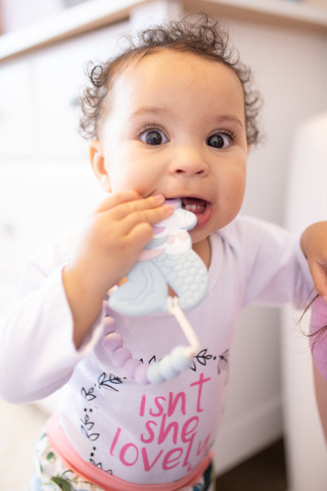 baby girl with chewing toy