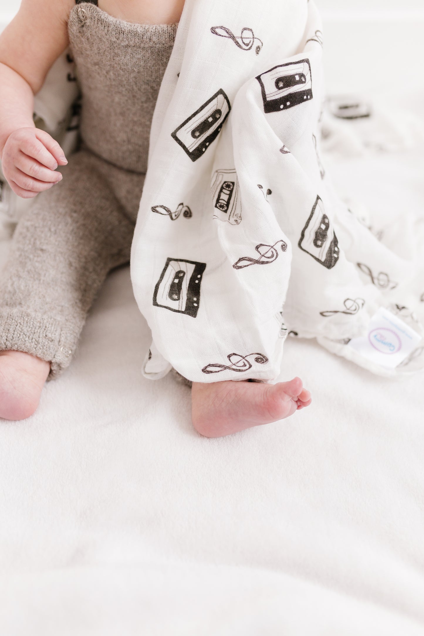 baby with cassette tape blanket