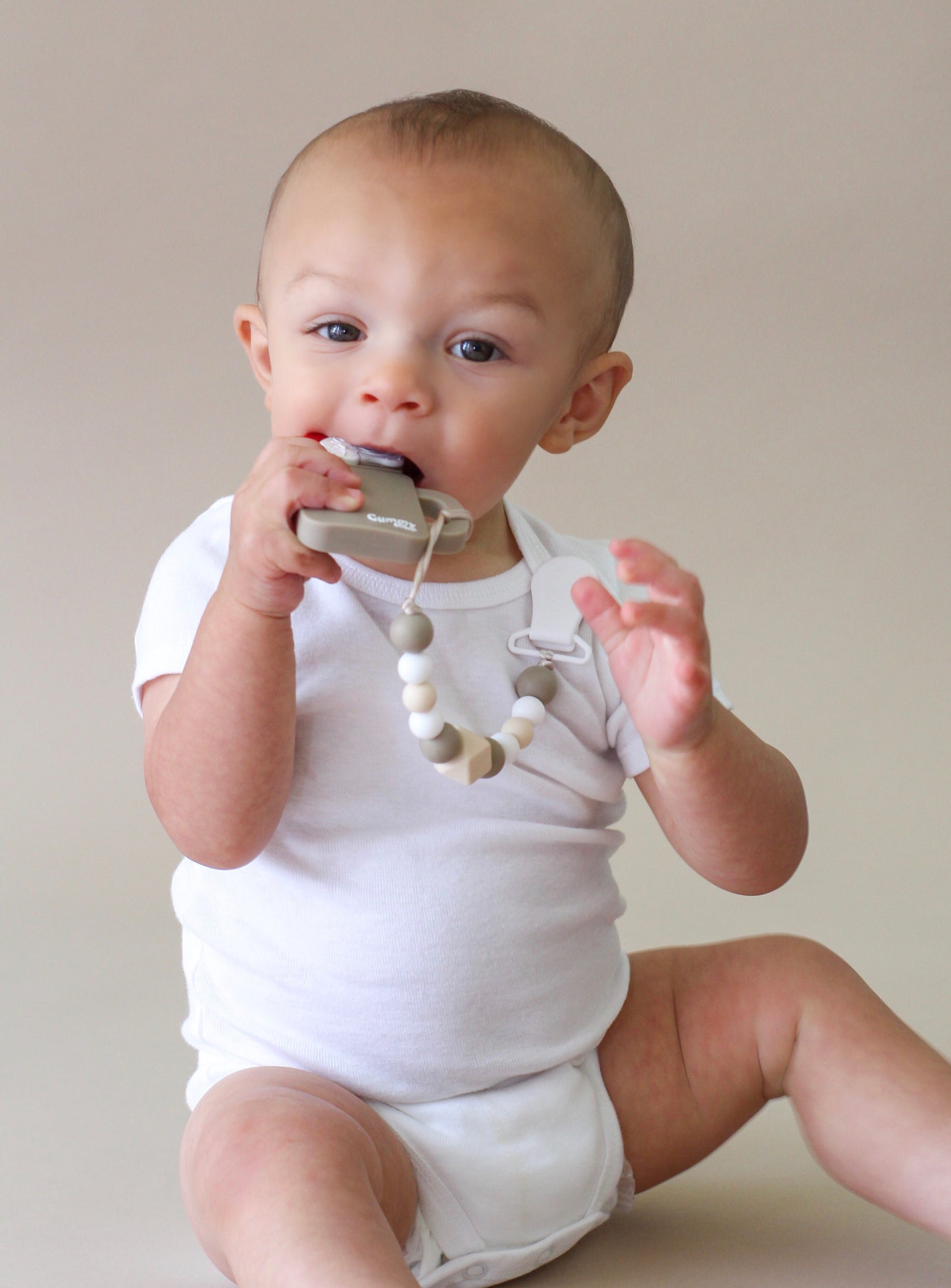 baby chewing on chocolate teether for teething stages