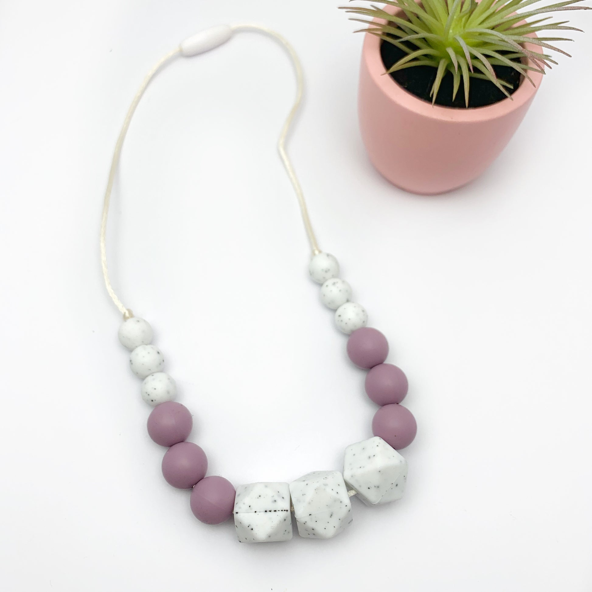 whtie and purple biting necklace