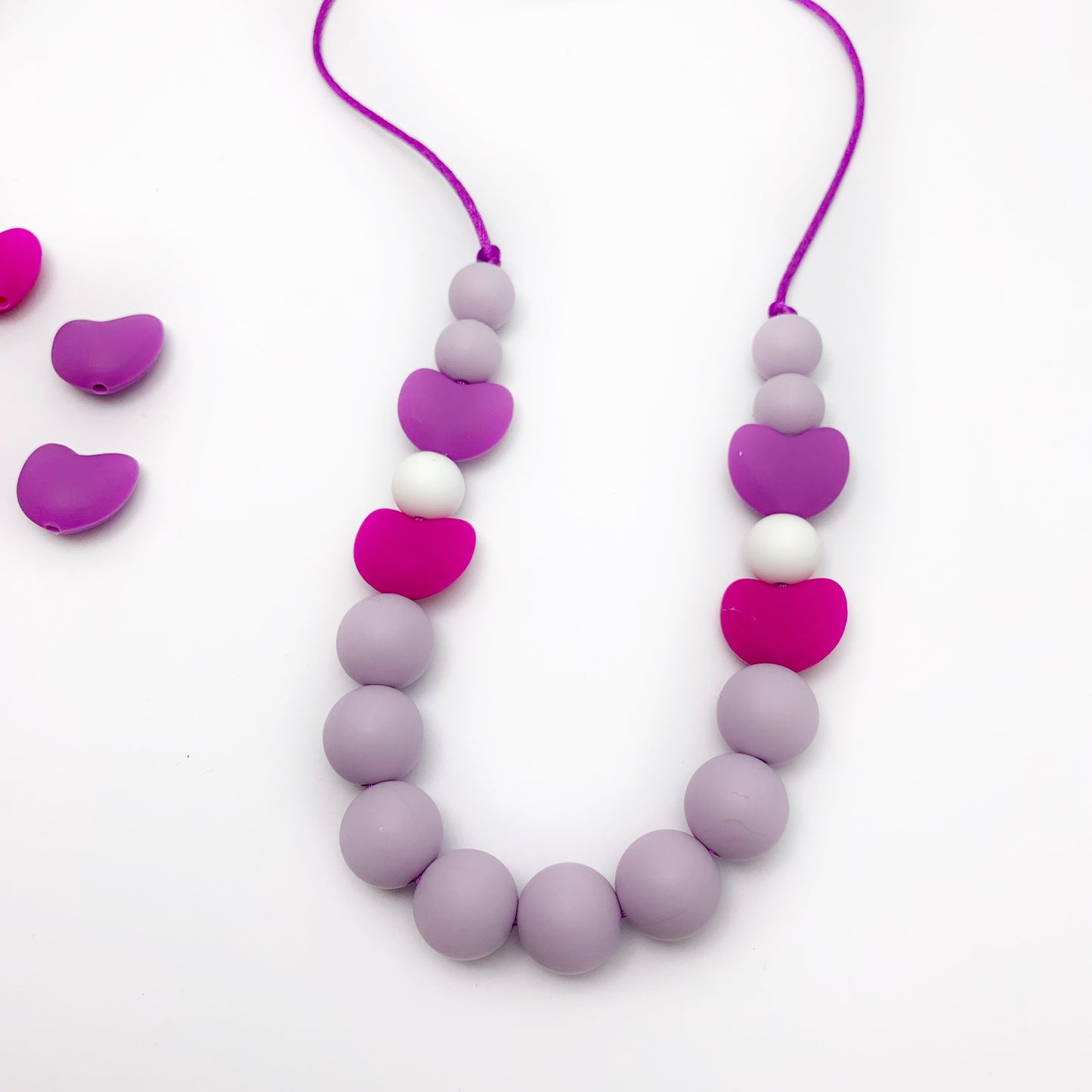 pink and purple heart chew necklace