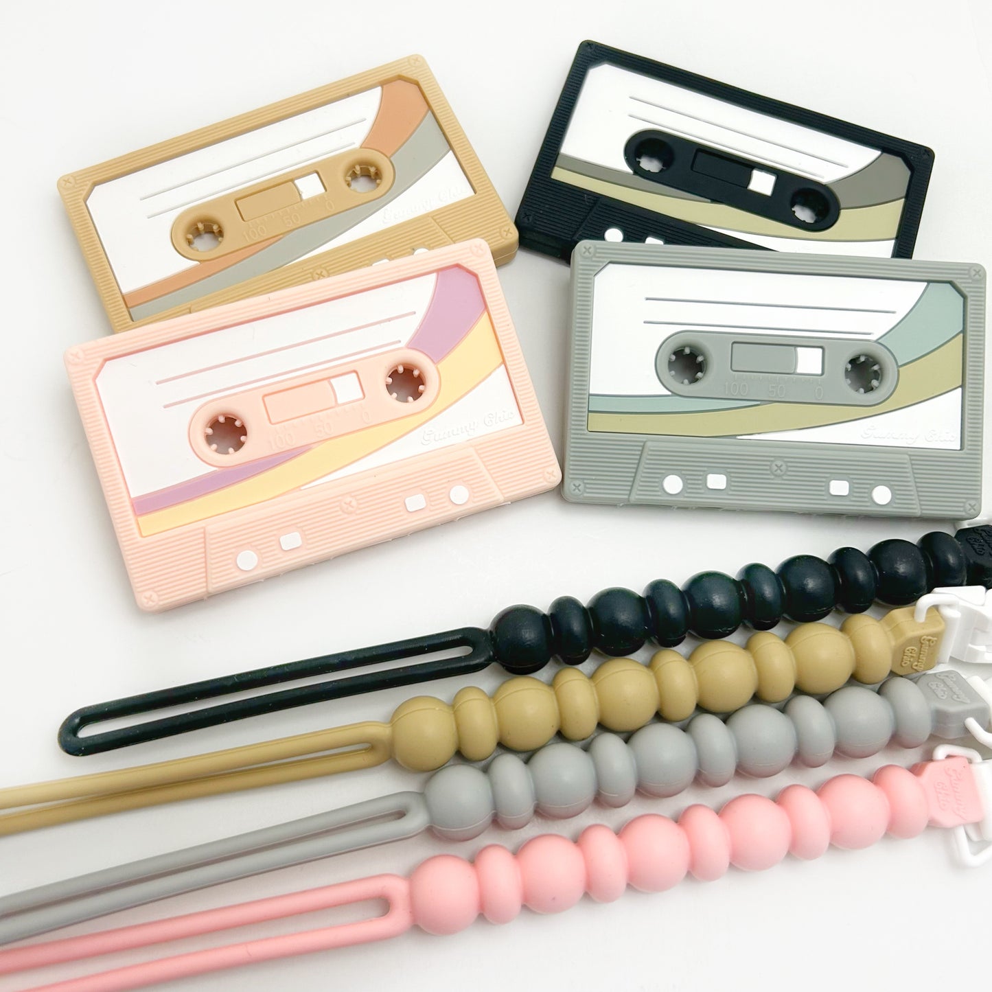 four cassette tape teethers in silicone with pacifier clips that match