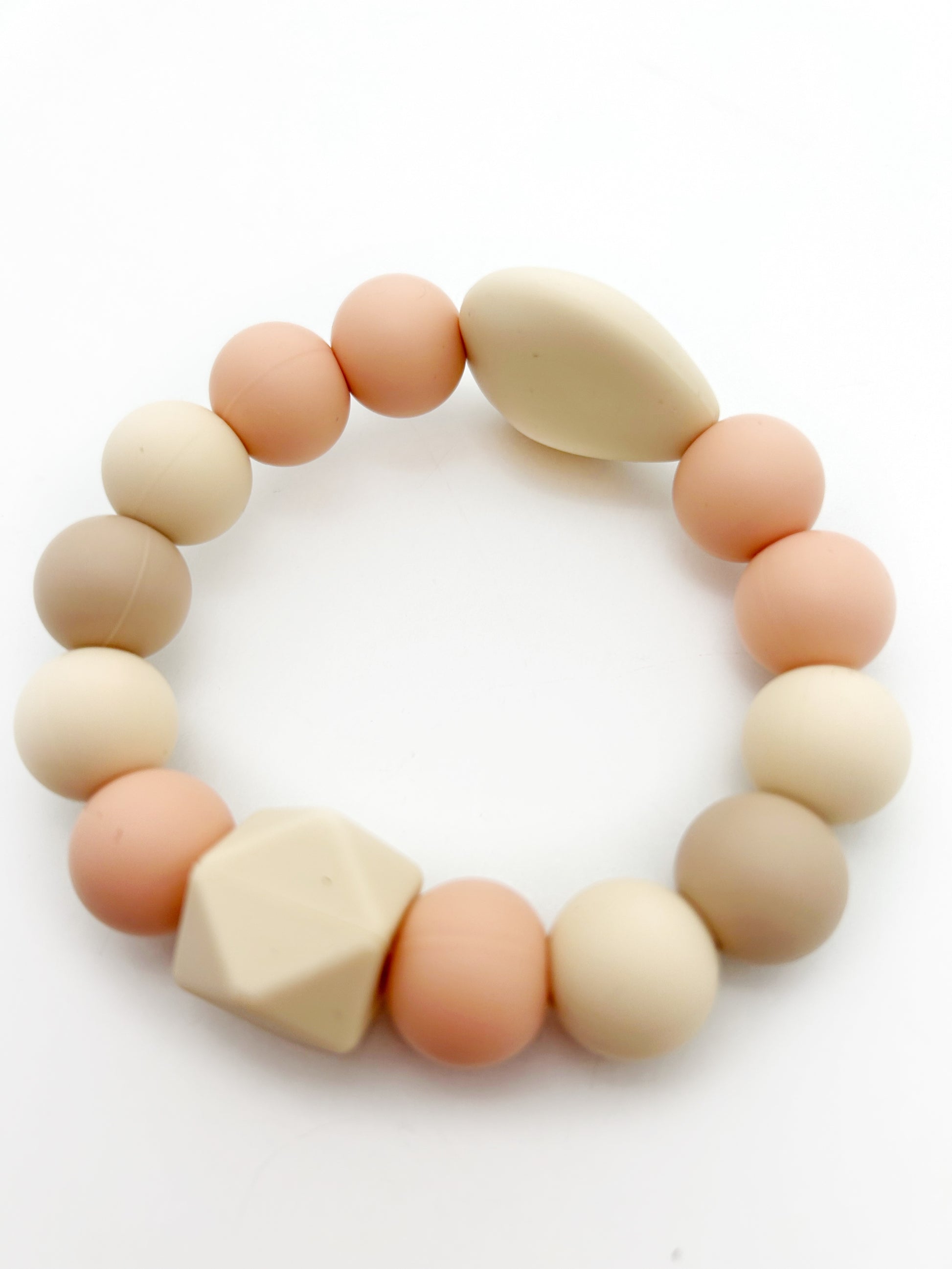 white background and detail view of a teething ring with silicone beads