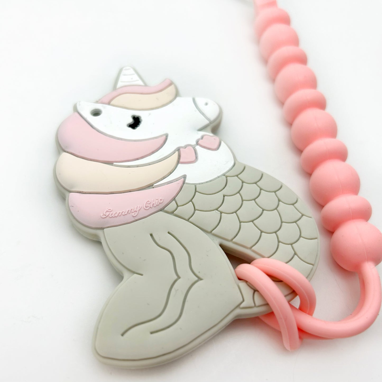 mermaid and unicorn teether with a clip attached to it.