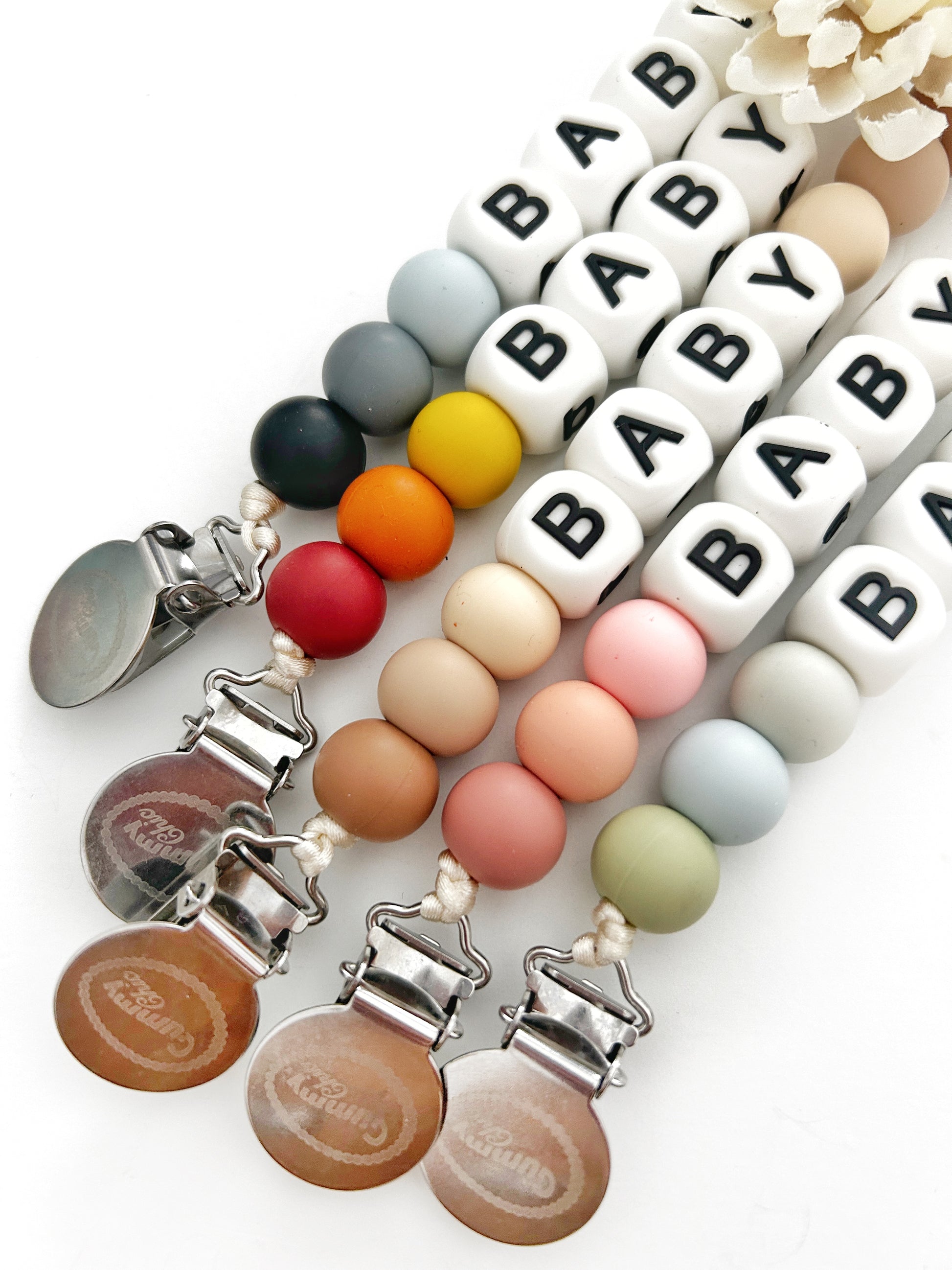 Different colored beads with personalized beads to add a name on the pacifier clip with stainless steel clips