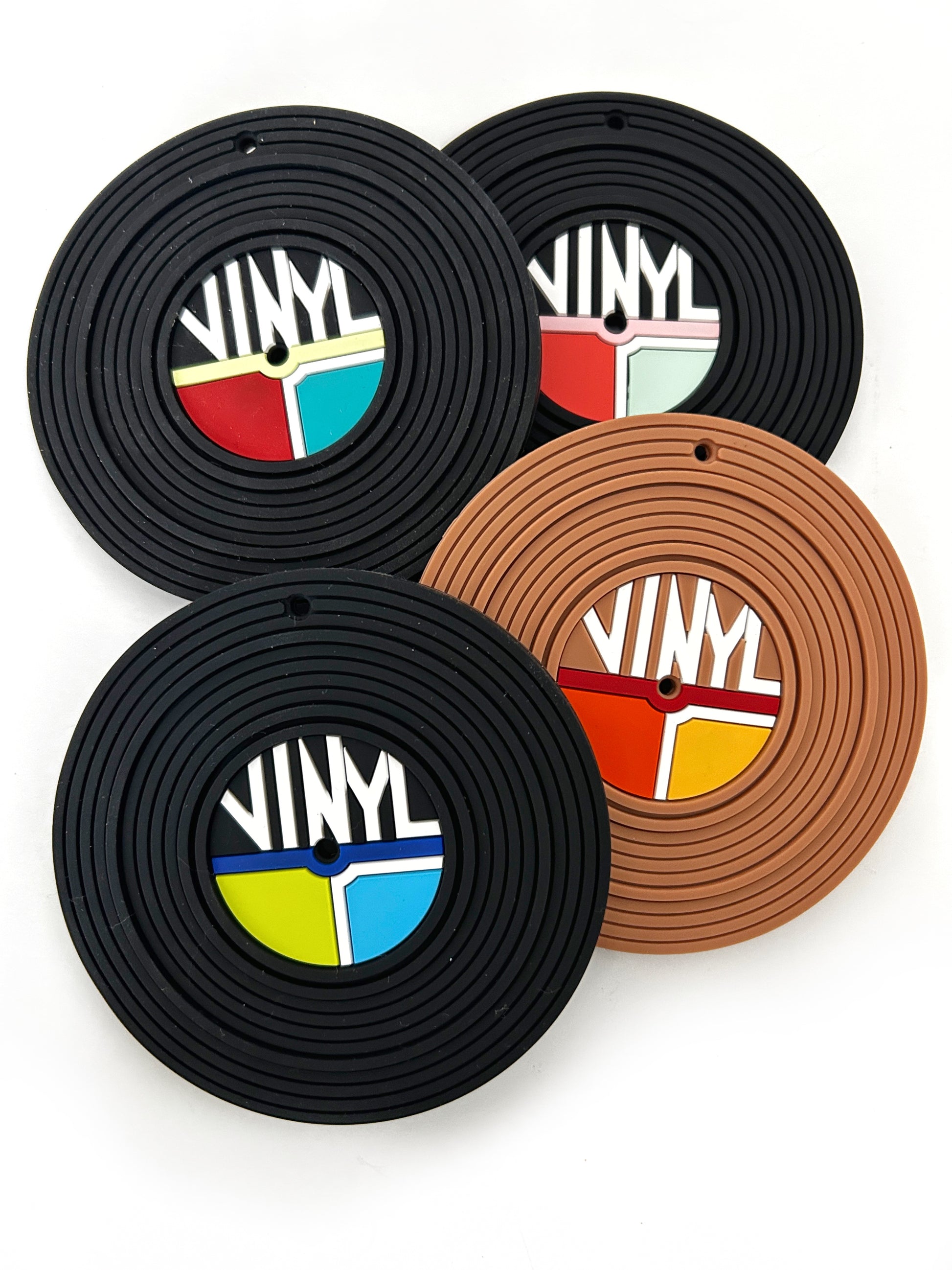 A collection of silicone teether toys designed to resemble vinyl records, in various colors including black, brown, and multicolored with a 'VINY' text pattern.