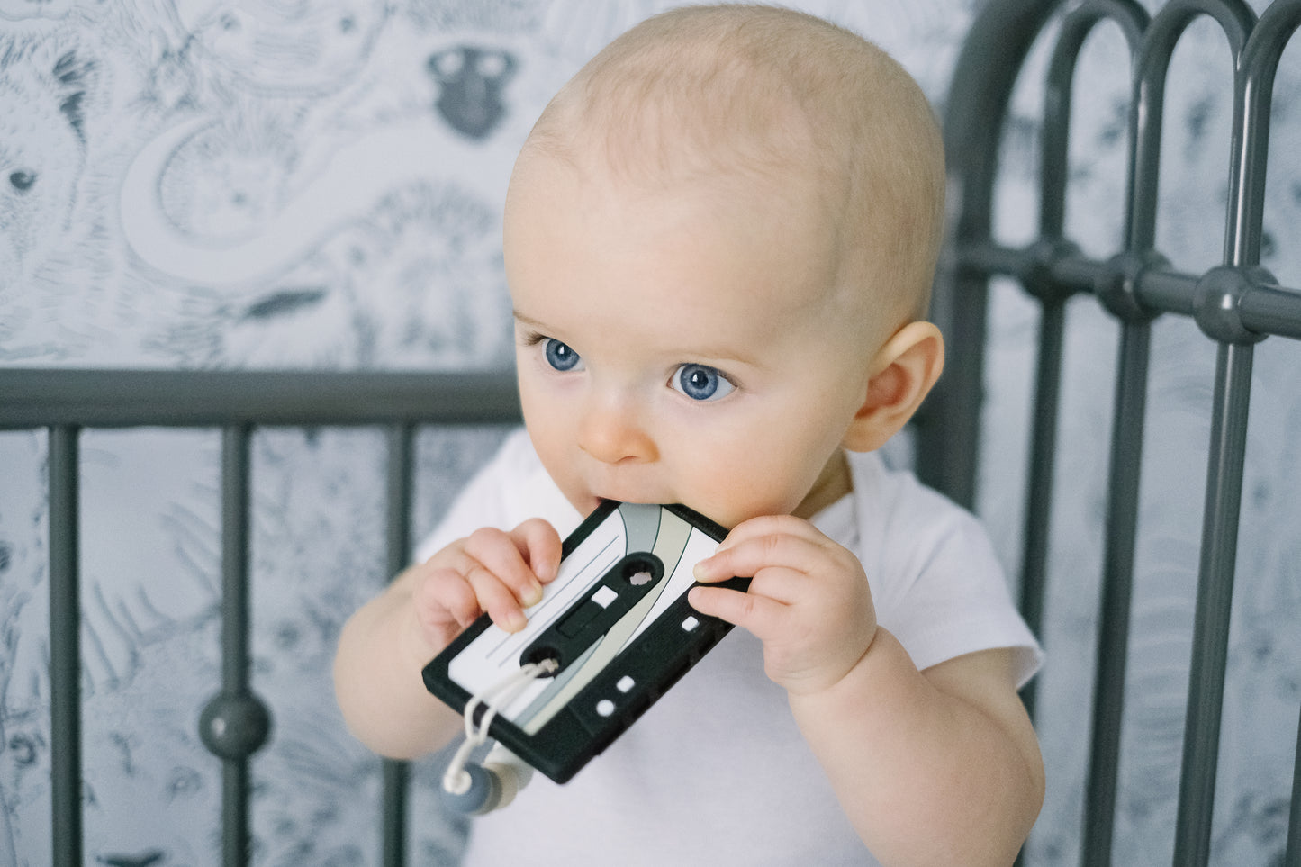 Baby chewing on a black mix tape teether toy