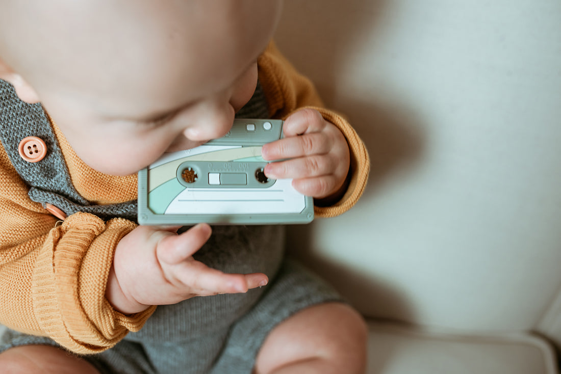 grey cassette teether being chewed by a baby 