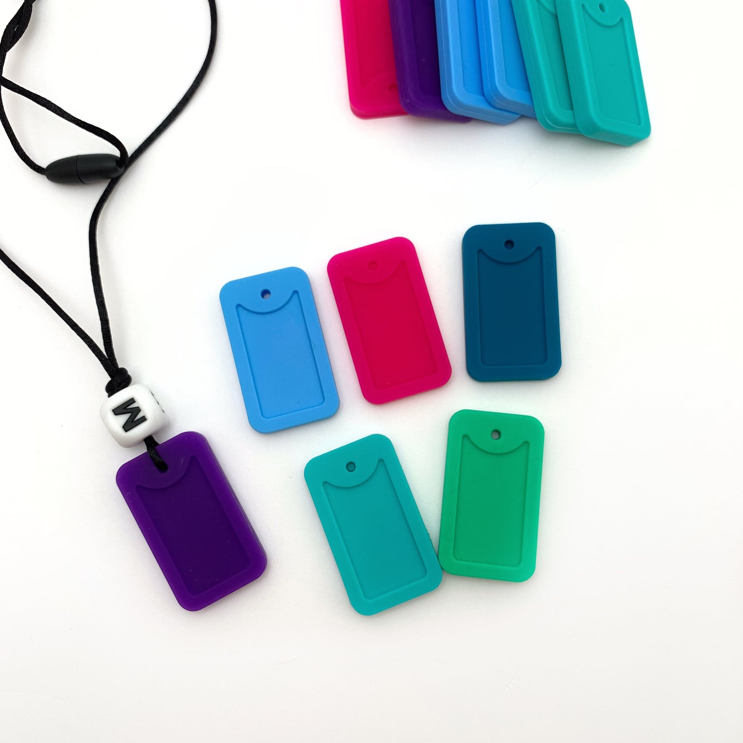 chew dog tags for oral stimulation with a letter bead for personalization