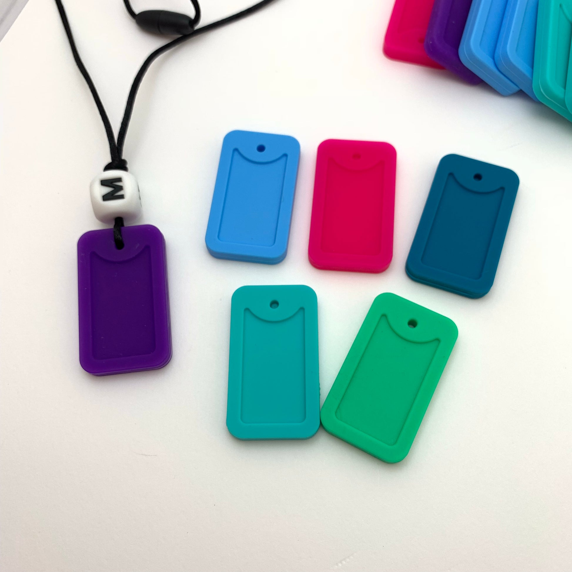 different colored dog tag silicone necklaces for chewing oral stimulation.